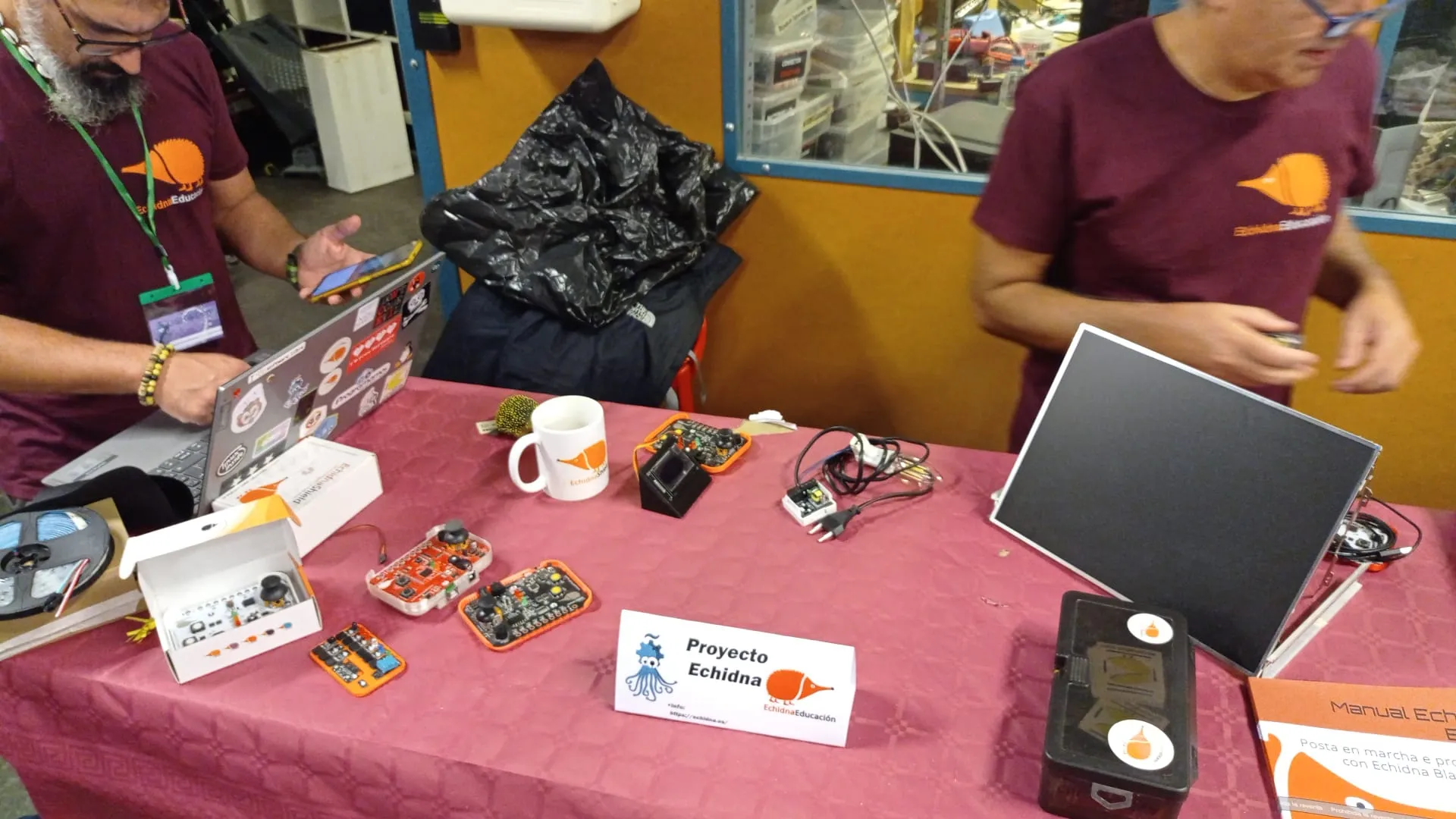El stand de Echidna, con placas, ordenadores y el cartel del proyecto.