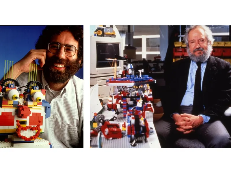 Mitchel Resnick junto a una cara de payaso hecha con LEGO, y Seymour Papert sentado junto a una mesa llena de construcciones de LEGO.